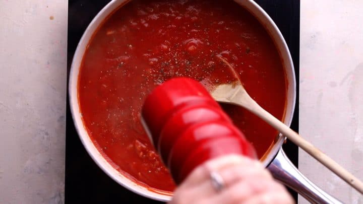 sauce simmering and black pepper being added sauce simmering and black pepper being added